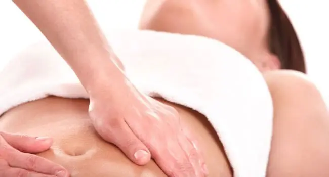 Therapist giving a body massage with both hands in our treatment room