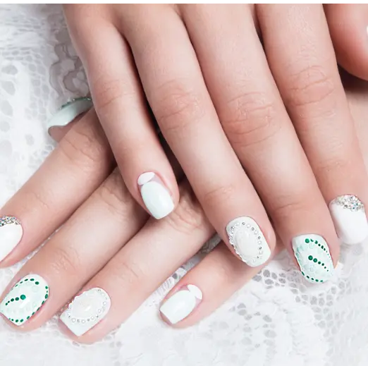 White nails with green hand-painted nail art designs