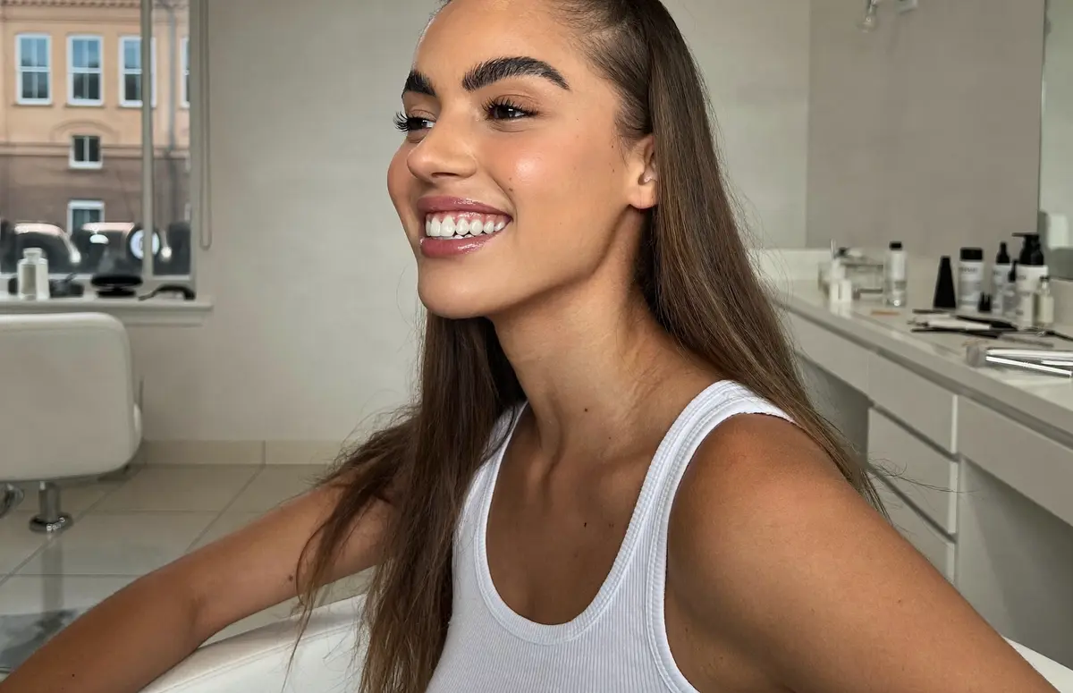 Smiling client with laminated eyebrows, full and brushed upwards